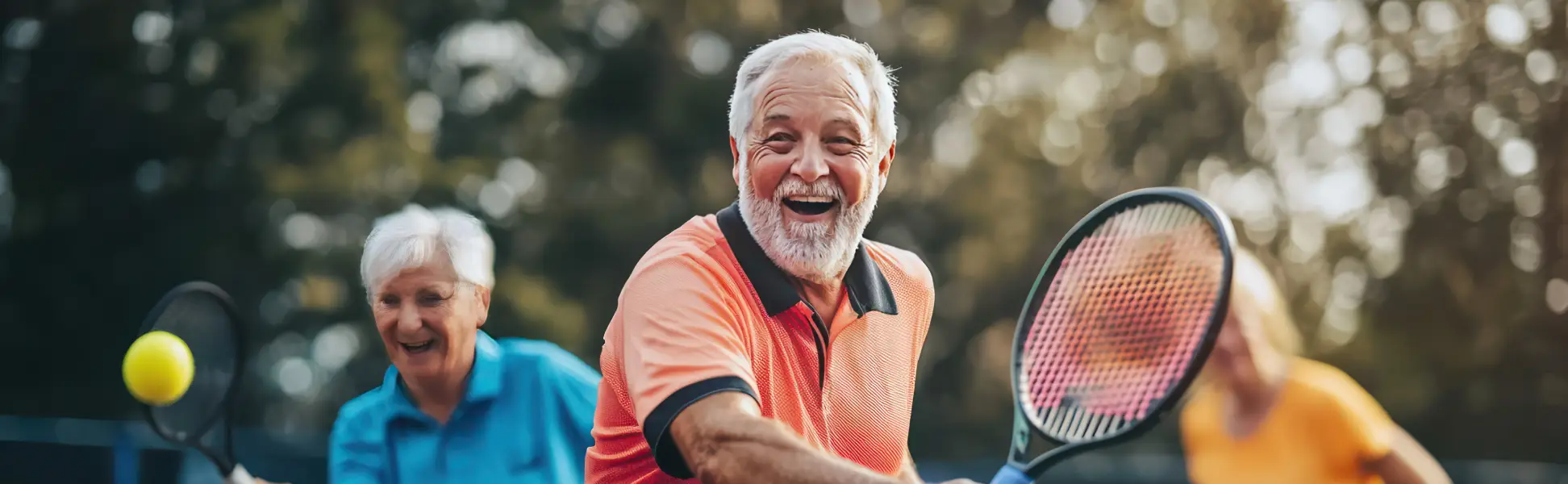 older adults playing tennis