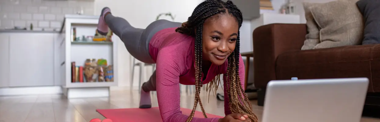 woman using laptop whilst doing yoga